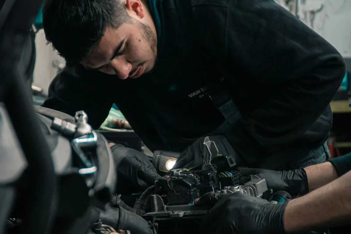 Technician inspecting a truck engine